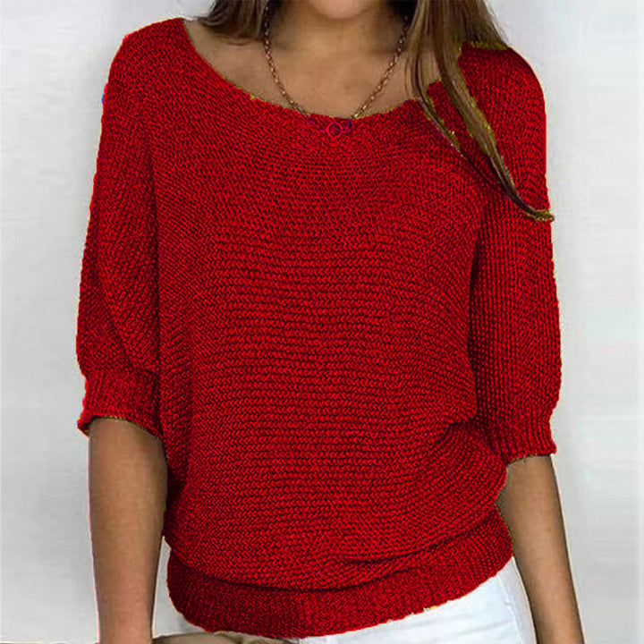 Woman relaxing in a Carla ultra-soft comfort sweater. Cozy long sleeve pullover for everyday style and winter warmth.