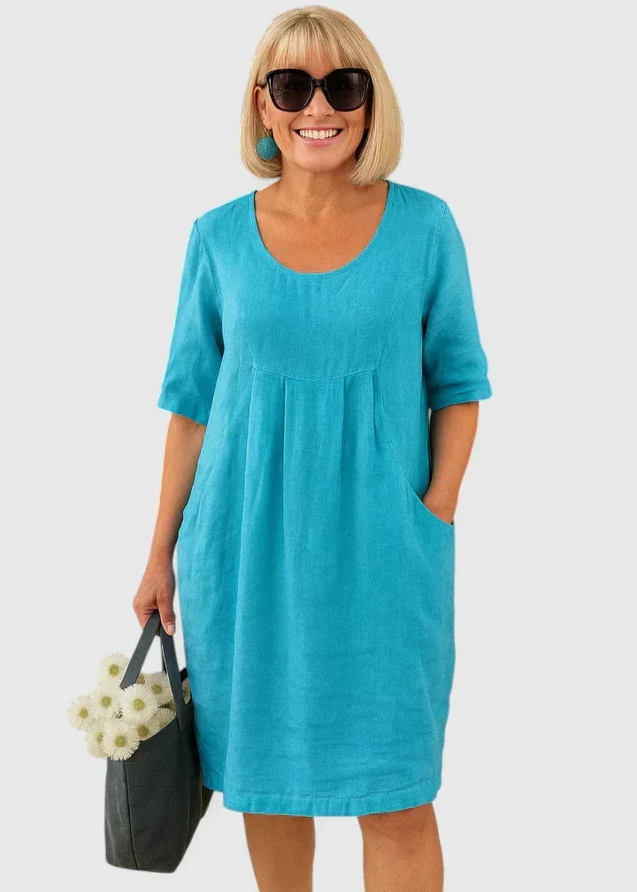 Stylish women's A-line summer midi dress; comfortable, relaxed fit with practical pockets for casual fashion.
