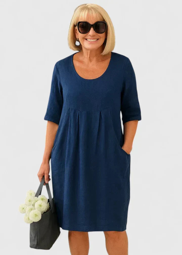 Elegant A-line women's midi dress in a casual summer style, featuring practical pockets & a scoop neck design.