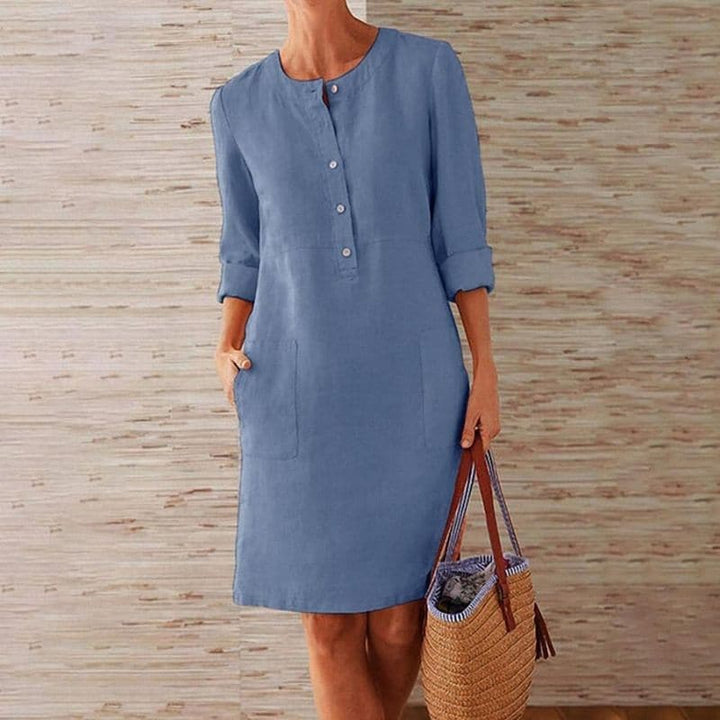Relaxed fit women's midi shift dress featuring button front, three-quarter sleeves & practical side pockets.