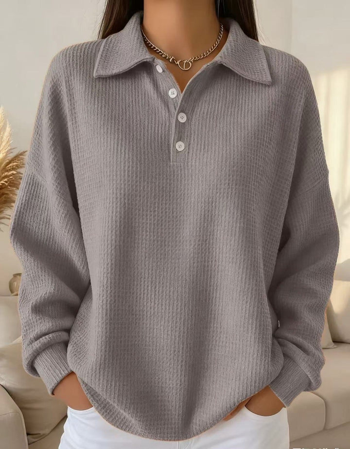 Chic women's Henley sweater, a versatile long-sleeve collared top for casual or smart autumn outfits.