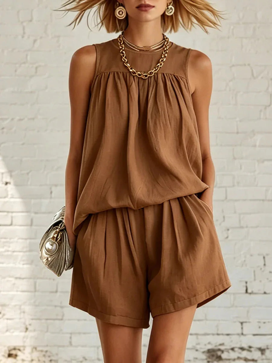 Comfortable women's casual shorts set. Features a flowy sleeveless top and gathered high-waisted shorts. Lounge wear.