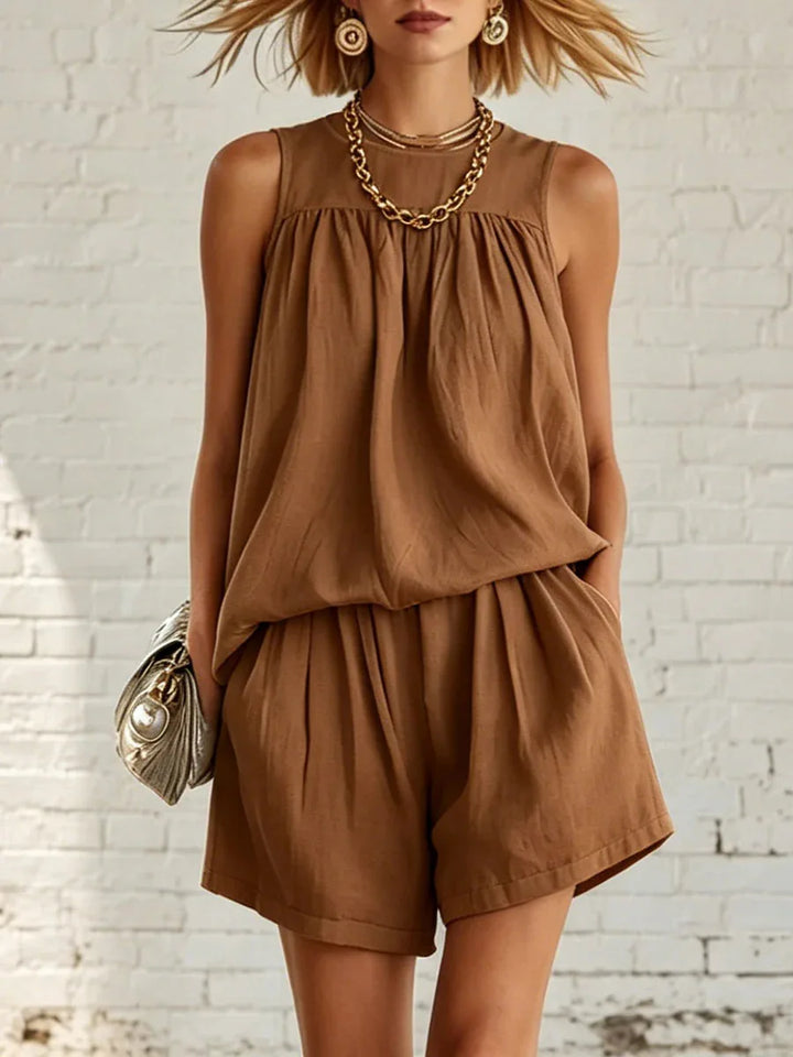 Comfortable women's casual shorts set. Features a flowy sleeveless top and gathered high-waisted shorts. Lounge wear.