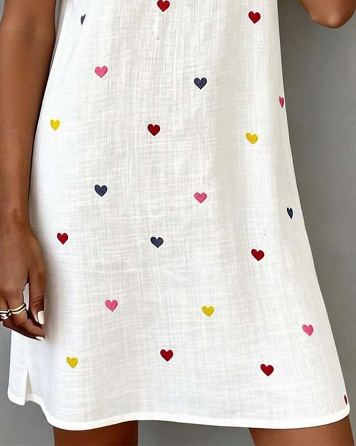 Comfortable short women's dress featuring a cute heart print & flattering V-neck, ideal for casual wear.