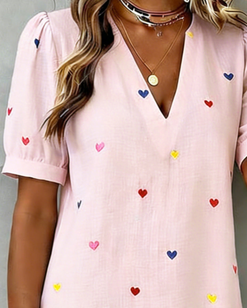 Everyday women's short dress with a playful heart pattern, V-neck design, and comfortable fit.