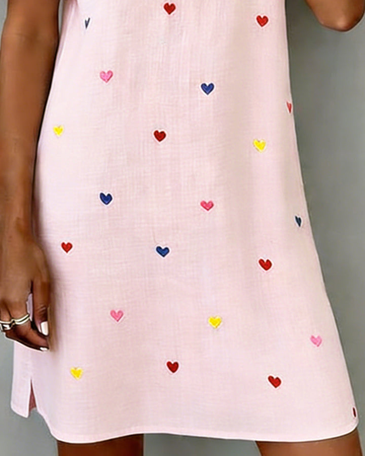 Front view of a women's casual V-neck dress, adorned with a delicate heart print and puff sleeves.
