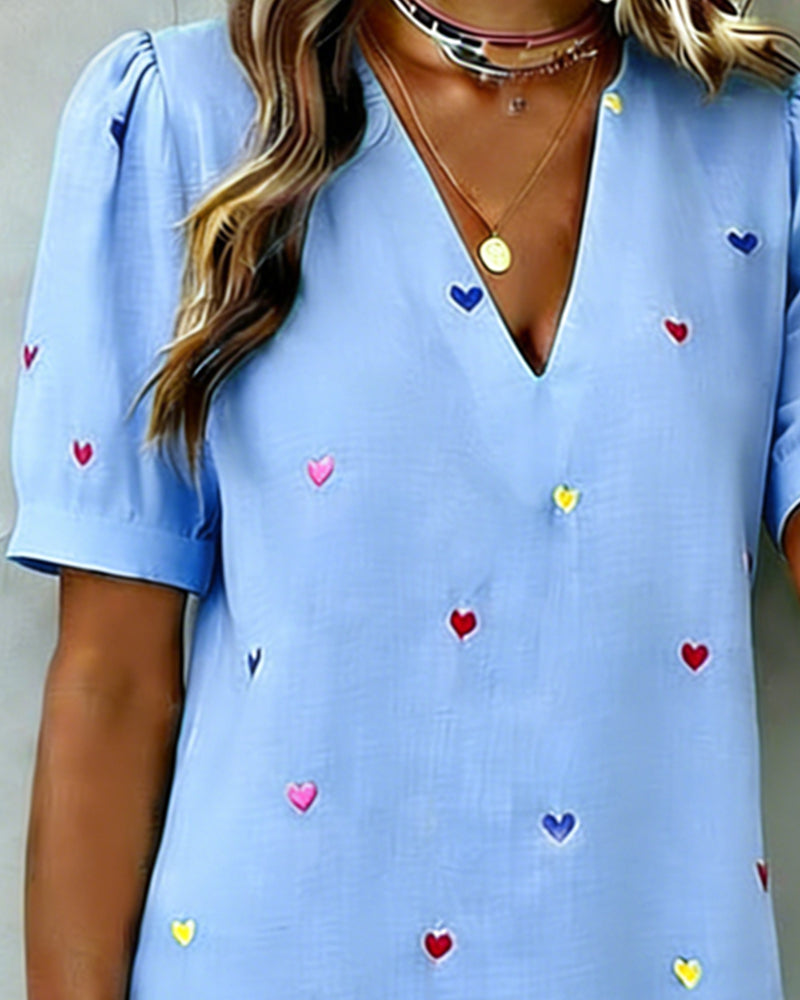 Soft fabric women's short dress, featuring a lovely heart print, V-neck, and fashionable puff sleeves.