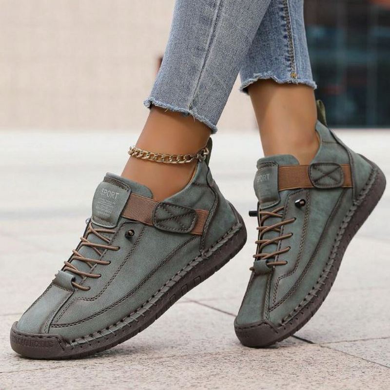 Stylish women's neutral-colored lace-up sneakers. Versatile stitched casual footwear for daily wear.