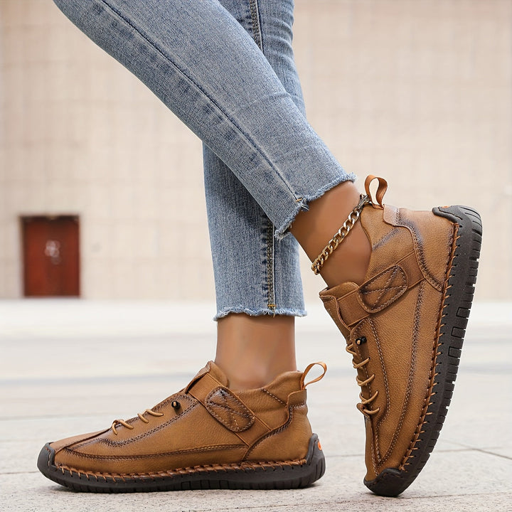 Woman wearing comfortable casual lace-up sneakers with stitched accents, perfect for everyday walking.