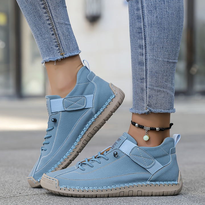 Women's everyday low-top lace-up sneakers. Features comfortable design and elegant stitched detail.