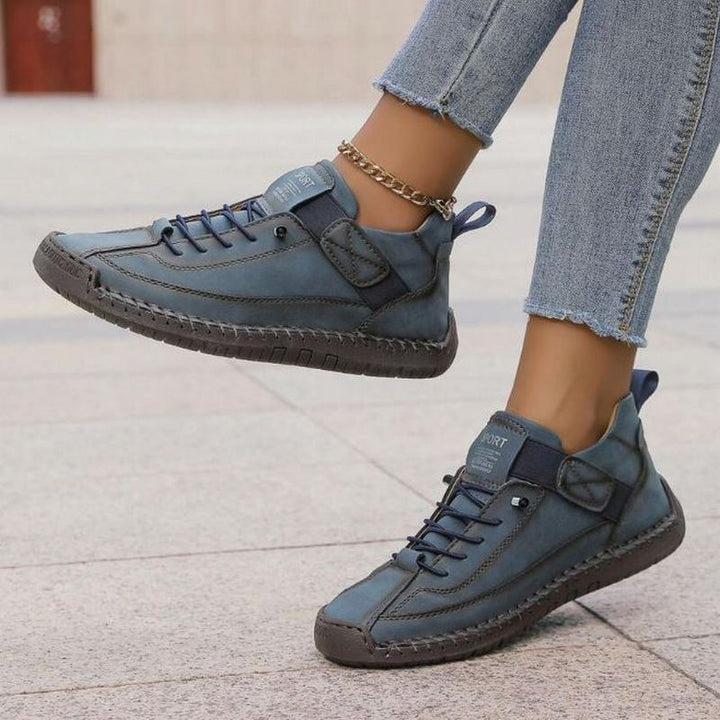 Women's casual lace-up sneakers, low-top design, stitched details, comfortable for everyday walking.