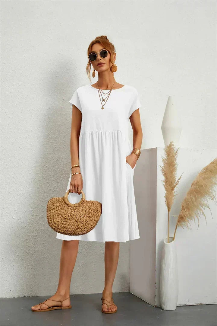 Comfortable women's midi dress featuring short sleeves & useful pockets, perfect for all-day wear.
