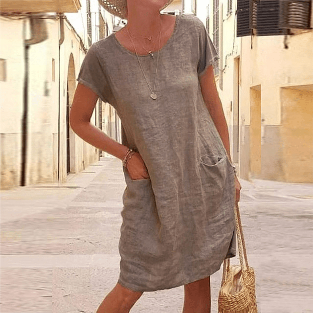 Relaxed fit women's casual mini dress with pockets, short sleeve. An essential summer dress for everyday wear.