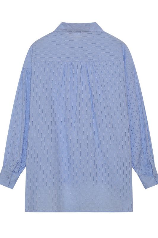Modern women's two-piece casual set, with a trendy shirt and matching shorts for summer.