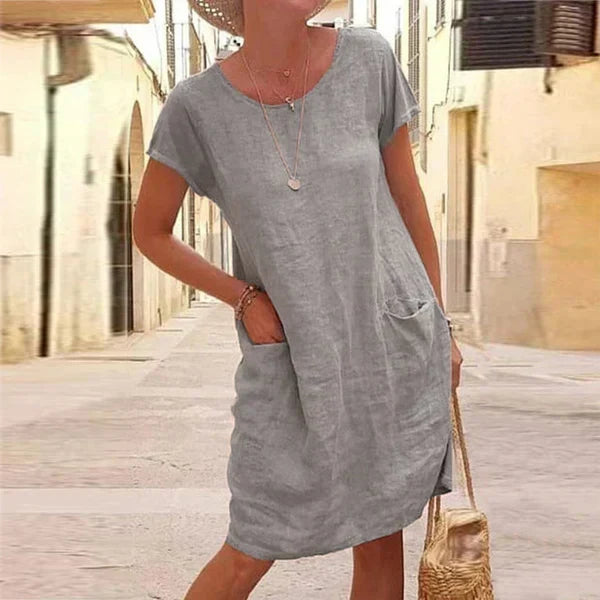 Relaxed fit women's short sleeve midi dress with pockets, perfect for versatile casual and comfortable summer wear.