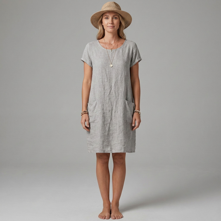 Flattering round neck mini dress for women. Short sleeves & pockets make this a practical choice for summer outings.