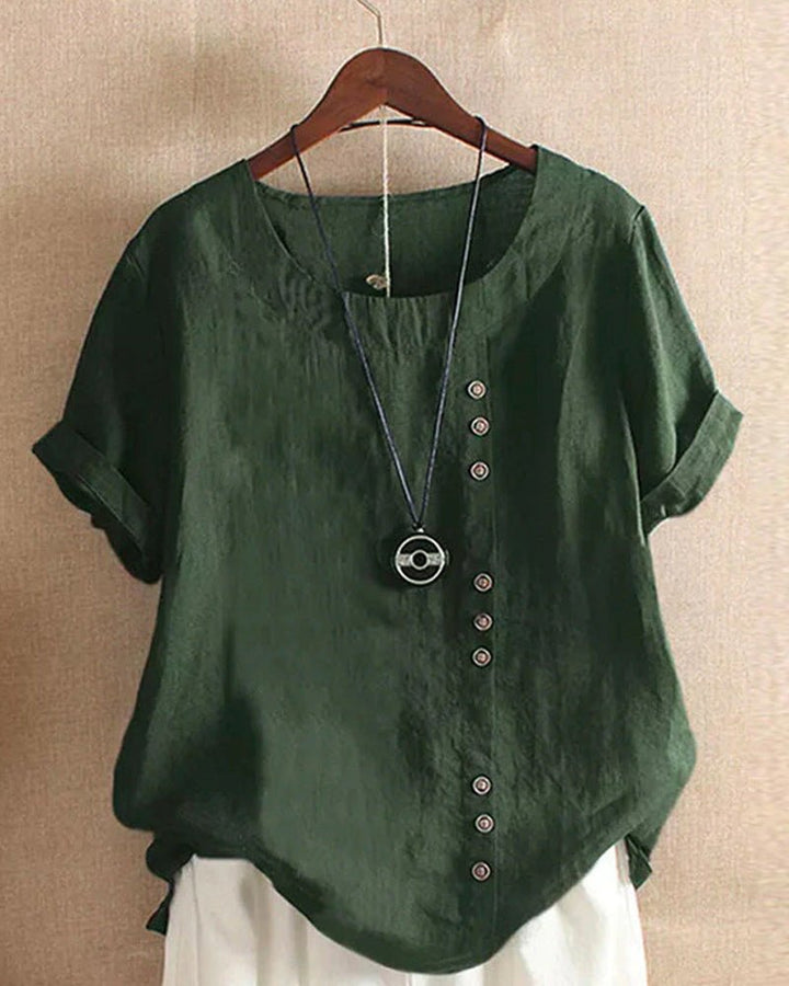 Fashionable women's short sleeve casual top. Relaxed fit & button front offer comfort & style.