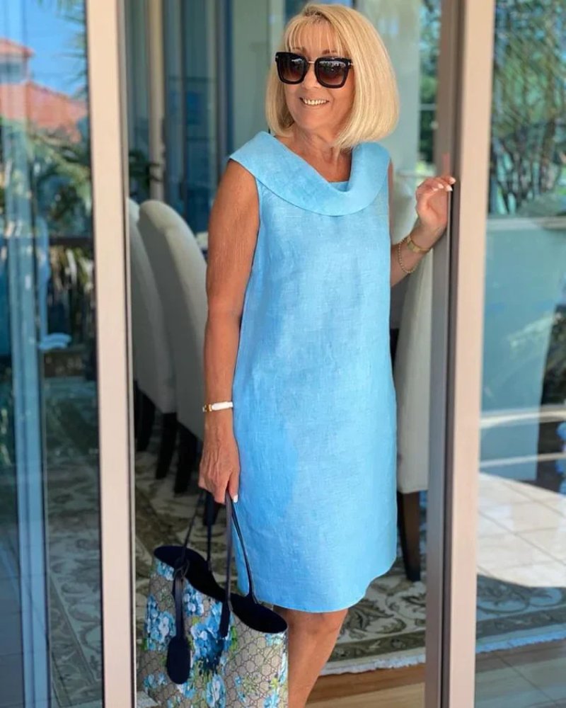 Relaxed fit women's knee-length shift dress with cowl neck and pockets, ideal for brunch or summer vacation.