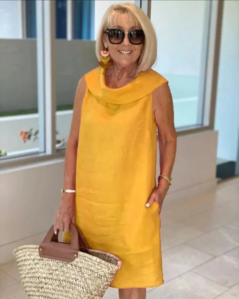 Sleeveless casual women's cowl neck shift dress with convenient pockets, versatile for summer outings and relaxed wear.
