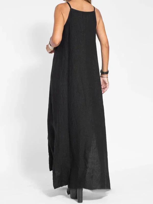Flowy women's sleeveless maxi dress in a solid color, featuring a stylish side slit & relaxed fit.
