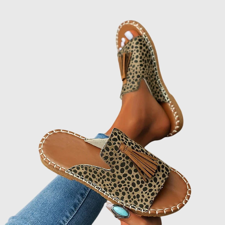 Comfortable women's vacation sandals, slip-on design with decorative tassel straps for summer.