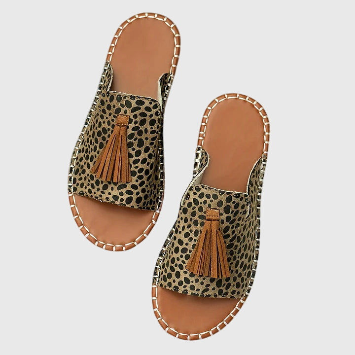 Trendy women's tassel strap slip-on sandals, ideal for summer fashion and beach outings.