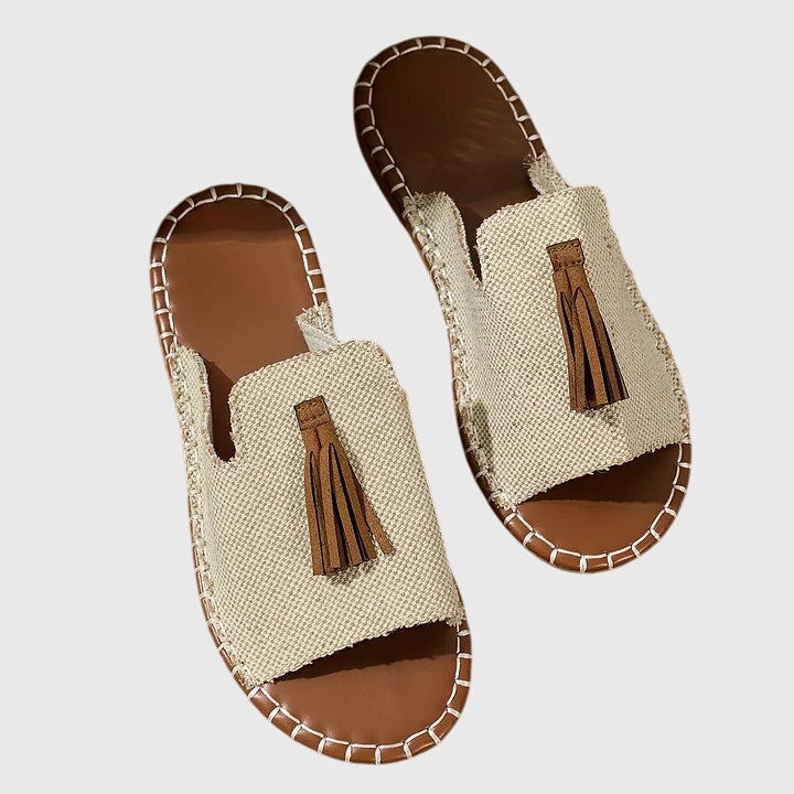 Women's everyday summer sandals, casual slip-on with flat sole and stylish tassel straps.