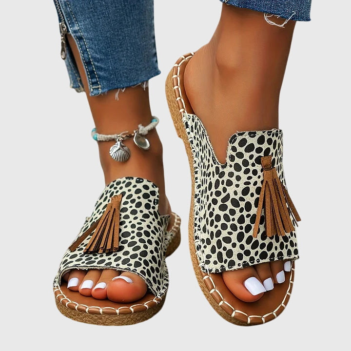Comfortable women's open-toe flat sandals with tassel straps, easy slip-on for summer.