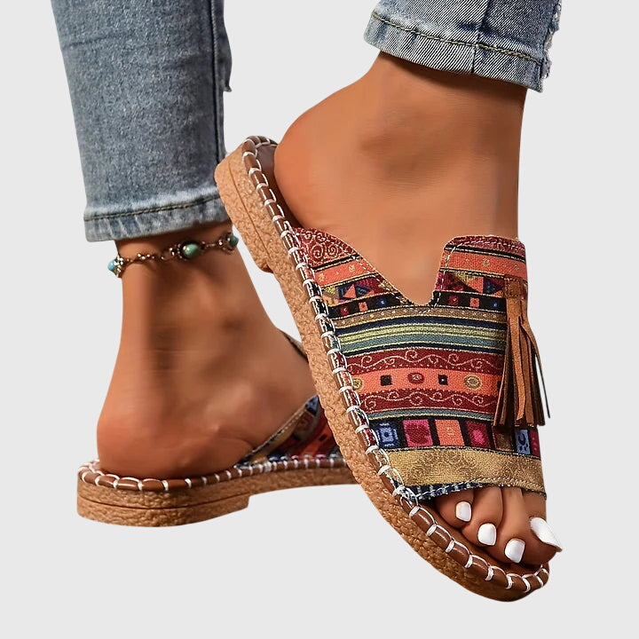 Open-toe women's slip-on sandals featuring chic tassel straps, comfortable for summer and beach.