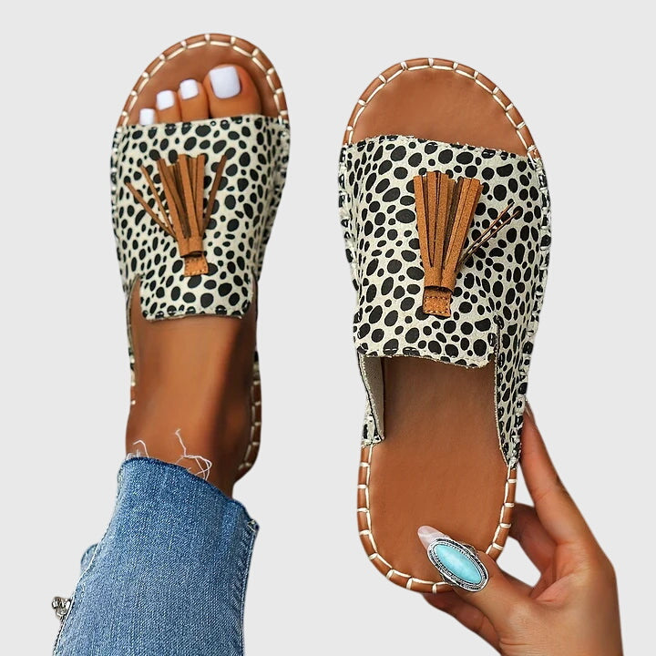 Women's flat sole summer sandals with cute tassel strap detail, great for casual everyday style.