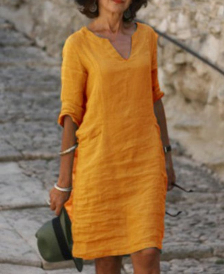 Women's flattering V-neck midi dress, a relaxed fit design for comfortable spring and summer days.