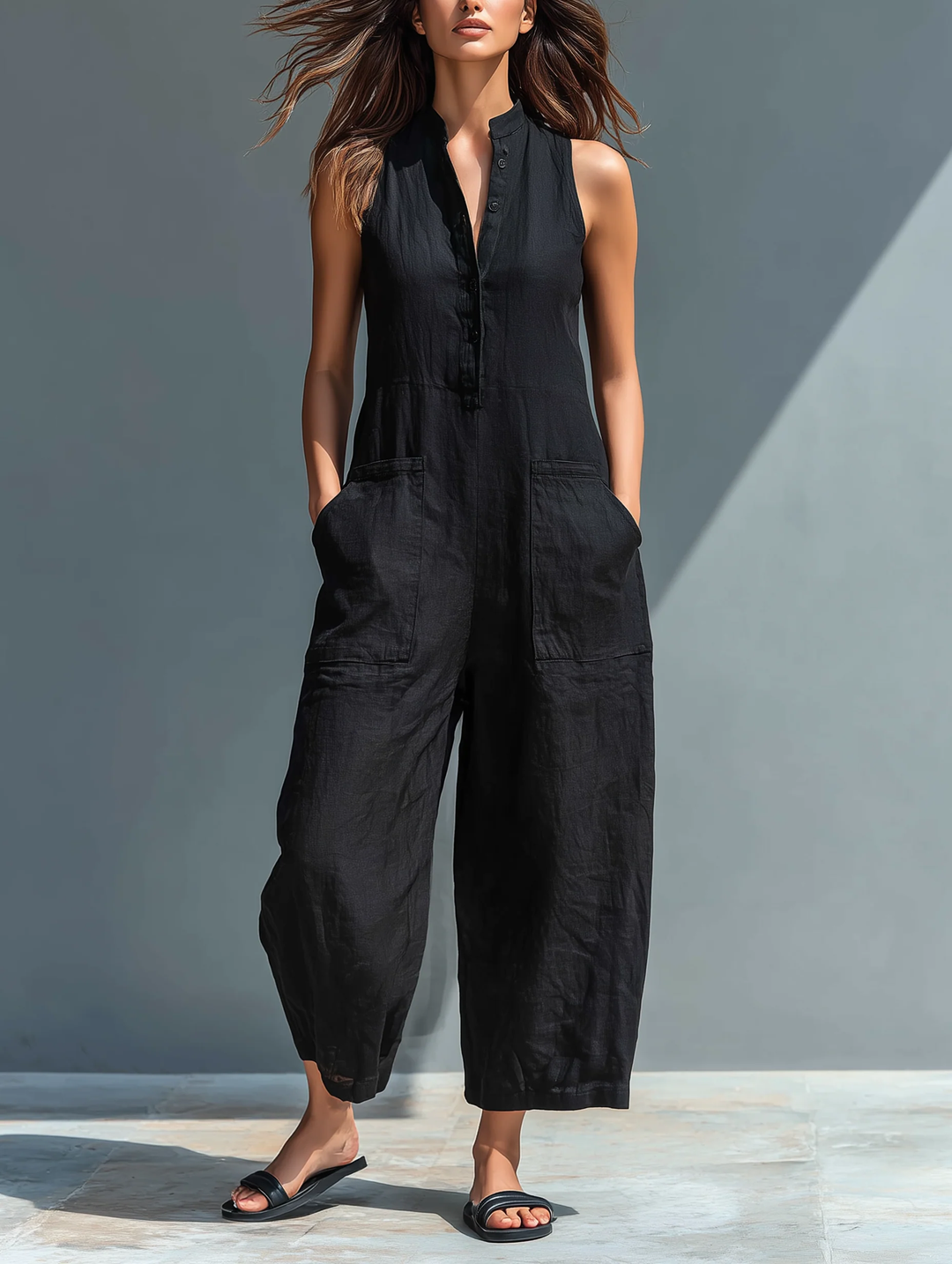 Women's chic black sleeveless button-up jumpsuit with loose fit, perfect for casual spring & summer style.