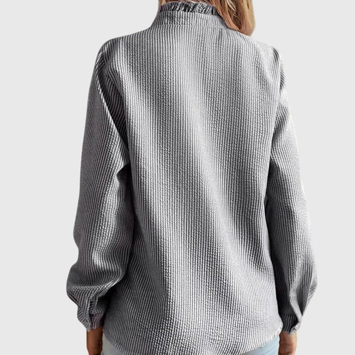 This chic women's blouse offers versatile styling, a must-have elegant top for any occasion.