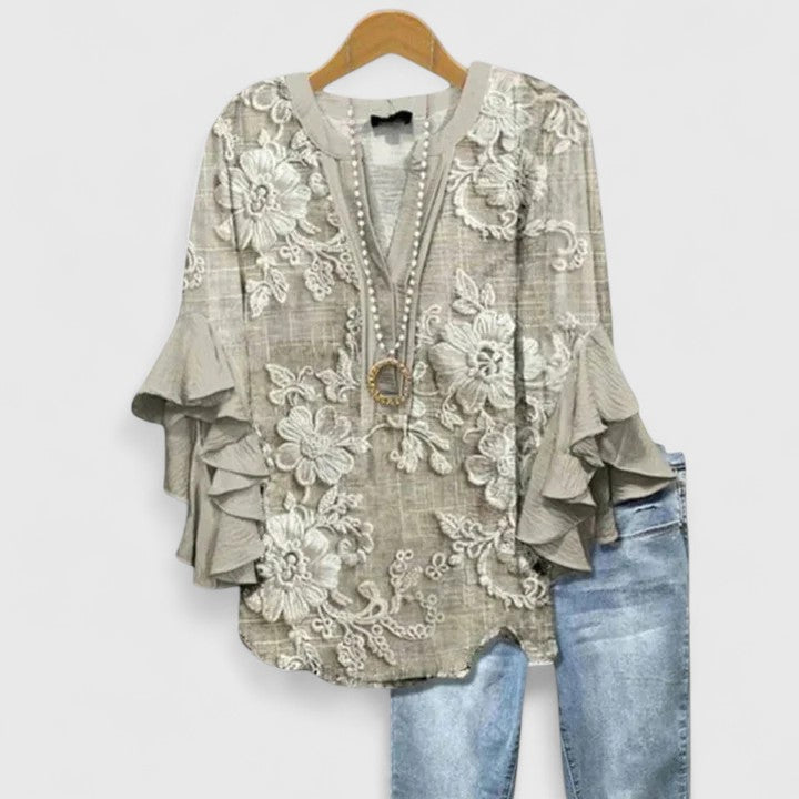 Elegant women's floral print blouse featuring delicate ruffled sleeves, ideal for summer fashion.