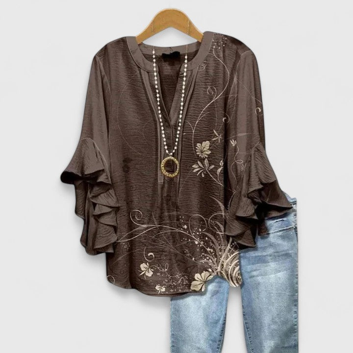 Modern women's floral top with stylish ruffled sleeves, a sophisticated addition to any wardrobe.