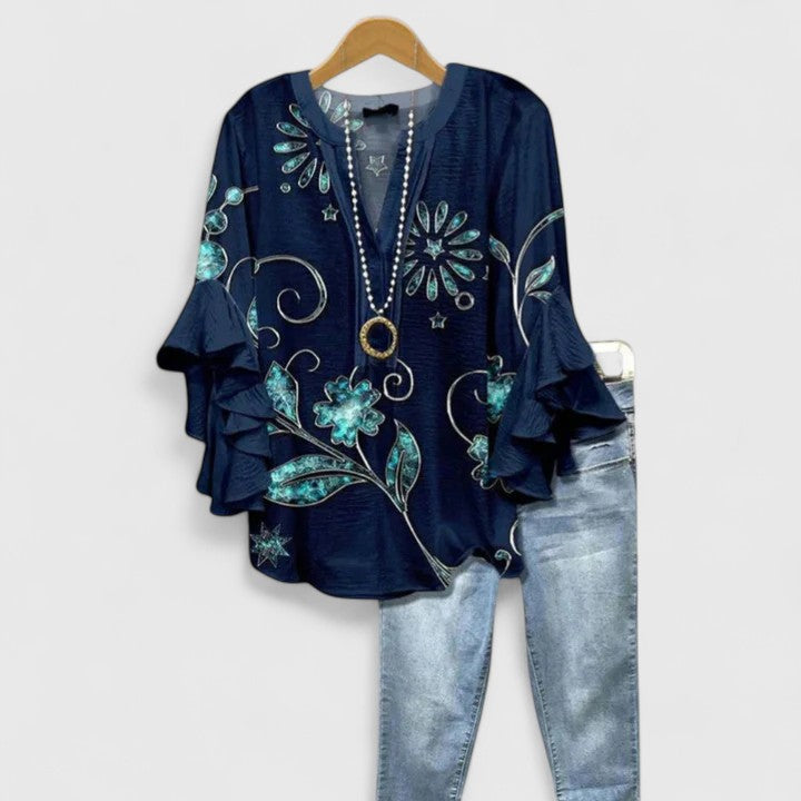 Lightweight floral women's blouse with comfortable ruffled sleeves, perfect for warm weather.