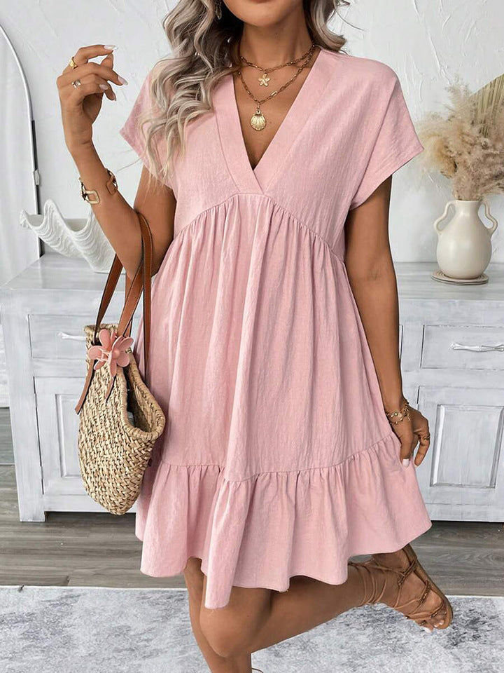 Lightweight women's summer mini dress featuring a cute ruffle hem & flattering V-neck. Chic & comfortable for warm weather.