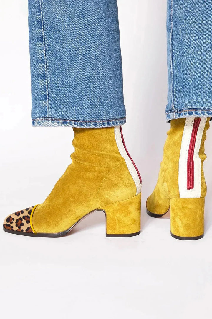 Modern women's heeled boots featuring a chic square toe and comfortable block heel.