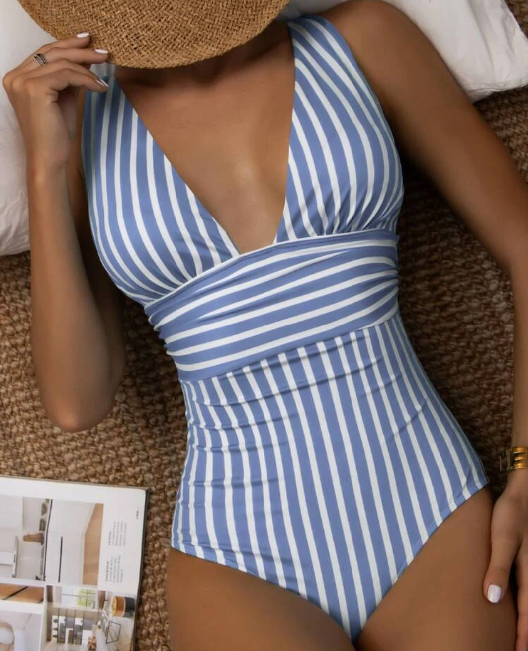 Elegant women's striped one-piece swimsuit, flattering and essential for summer vacation and beach fashion.