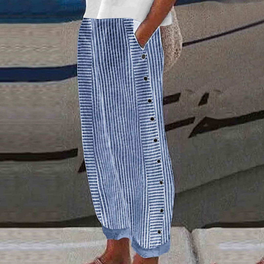 Stylish women's striped pants in a relaxed fit with chic button details, ideal for casual spring outfits.