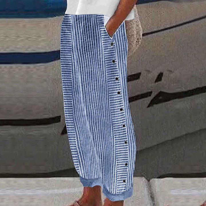 Stylish women's striped pants in a relaxed fit with chic button details, ideal for casual spring outfits.