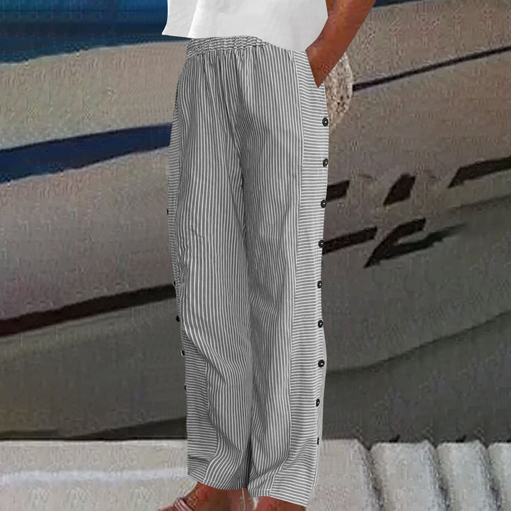 Model showcasing women's relaxed fit striped pants with button accents, comfortable & perfect for daily chic.