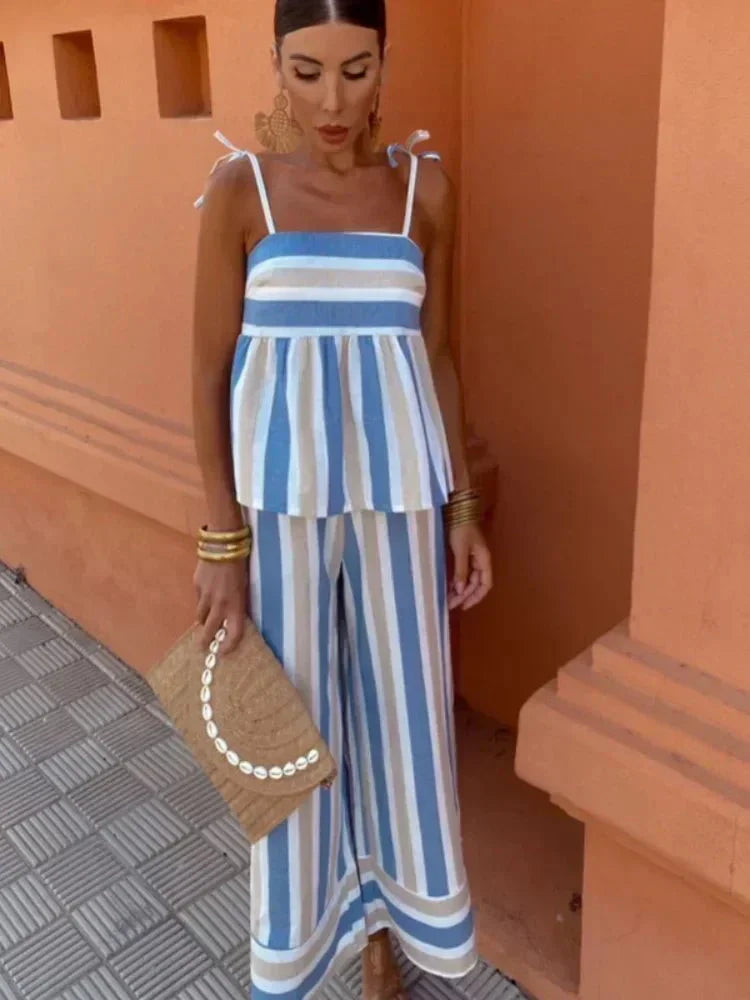 Women's chic striped wide leg two-piece wedding guest outfit with peplum top, perfect for summer events.