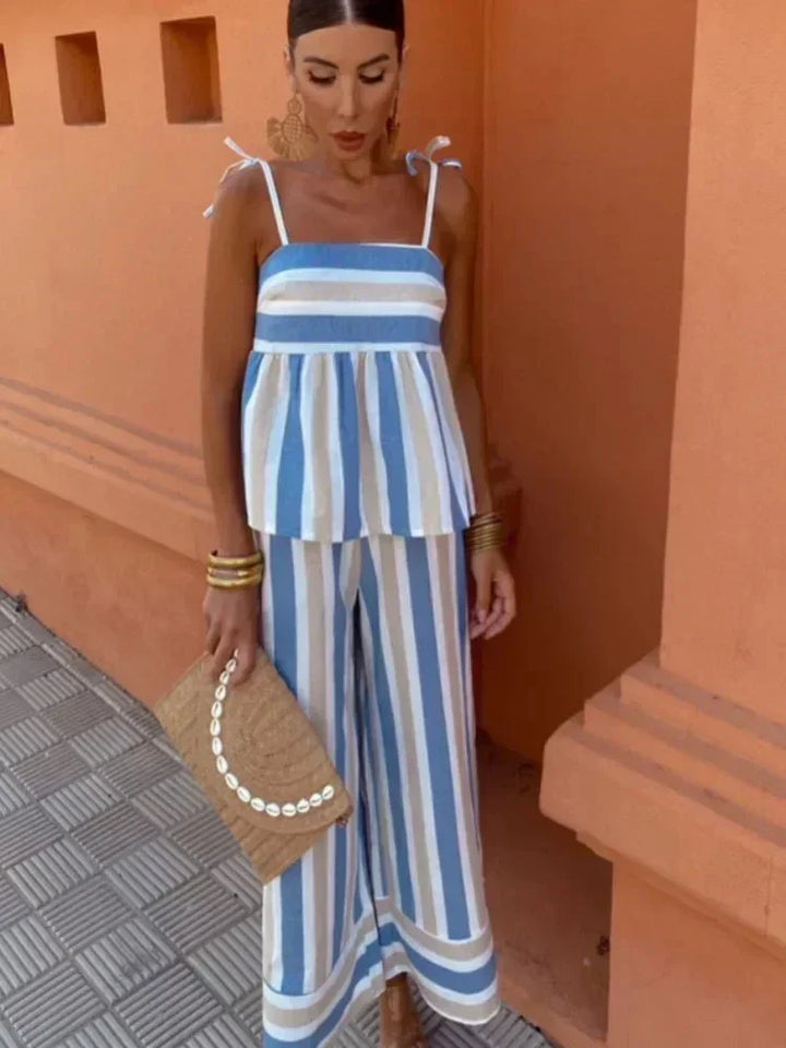 Women's chic striped wide leg two-piece wedding guest outfit with peplum top, perfect for summer events.