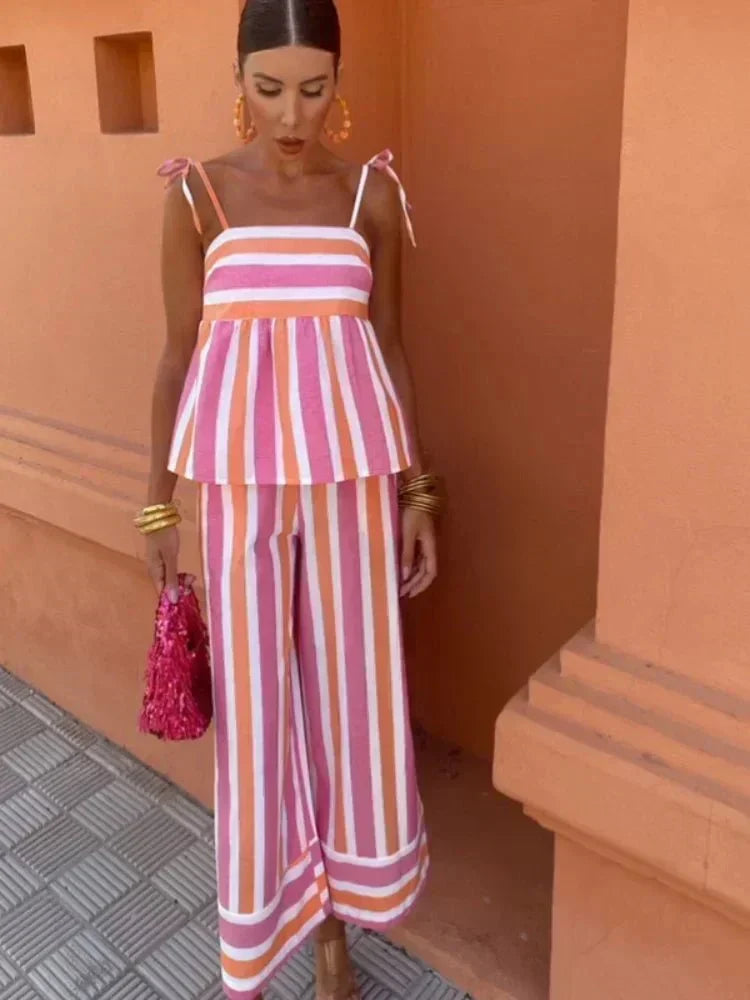Elegant striped two-piece set for women, featuring a peplum top & wide leg pants, ideal for wedding guests.