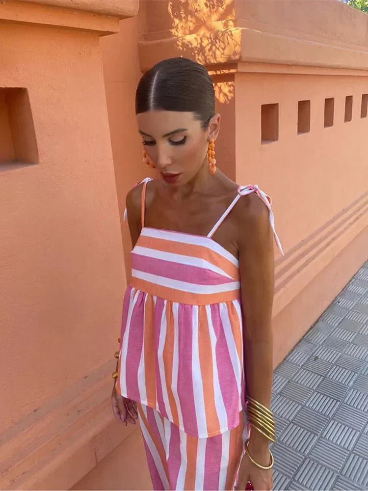 Party wear: Women's elegant striped peplum top & wide leg pants two-piece set, perfect for wedding guests.