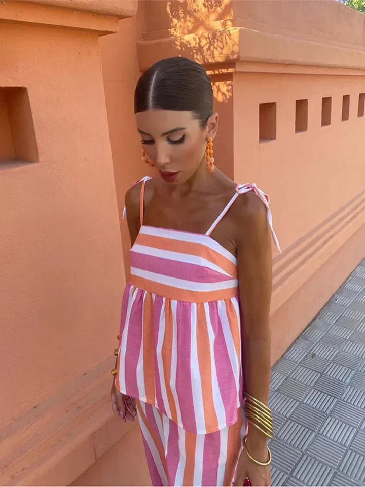 Party wear: Women's elegant striped peplum top & wide leg pants two-piece set, perfect for wedding guests.