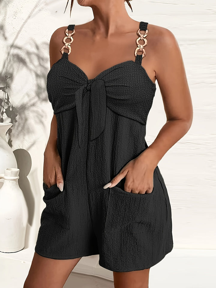 Women's chic textured romper with elegant chain straps & a stylish bow front. Perfect for summer fashion.