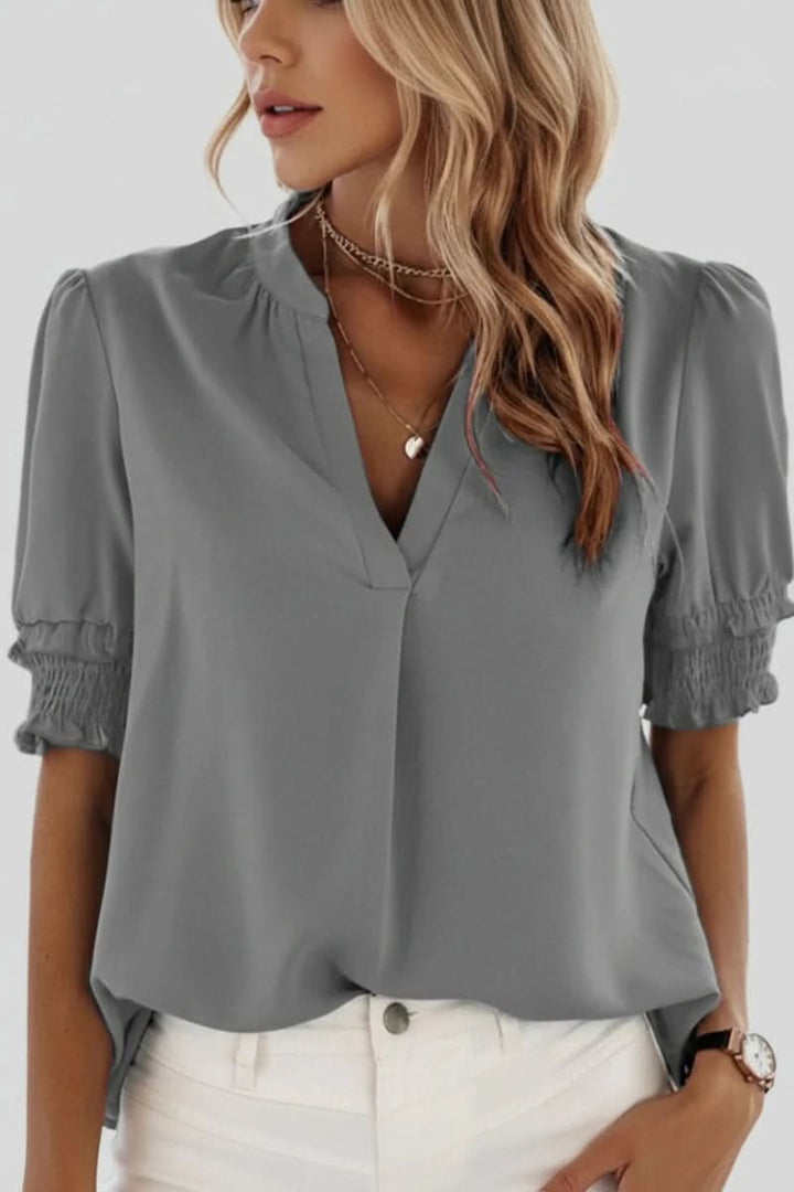 Effortlessly chic women's V-neck puff sleeve blouse. A stylish short sleeve top for elegant spring summer fashion.