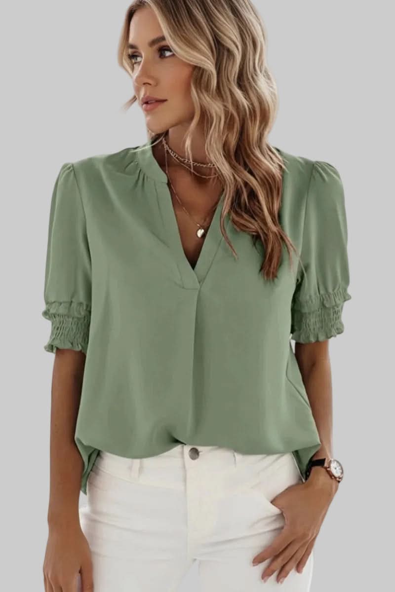 Elegant women's V-neck blouse featuring stylish puff sleeves. Versatile short sleeve top, perfect for summer chic.